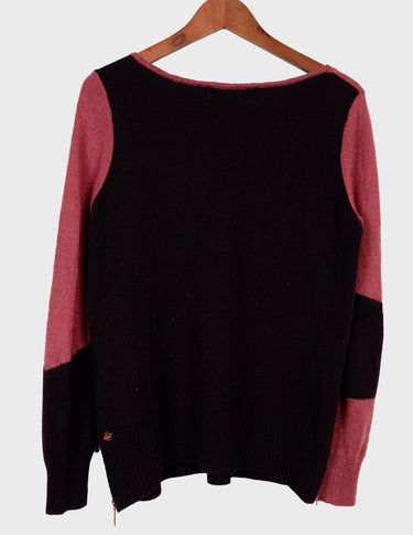 an asian woman is wearing a pink sweater.