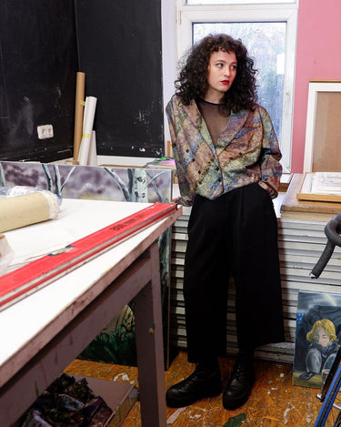 This vintage '80s blazer is sure to make a statement! Cropped and lightweight with an eye-catching, floral shimmer pattern, this funky piece of fashion will be sure to bring some drama to your look. Throw it on with shoulder pads for added edge (removable shoulder pads).