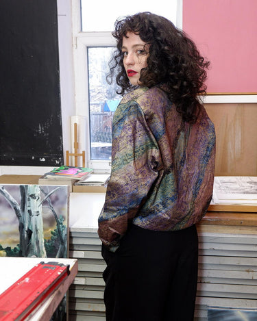 This vintage '80s blazer is sure to make a statement! Cropped and lightweight with an eye-catching, floral shimmer pattern, this funky piece of fashion will be sure to bring some drama to your look. Throw it on with shoulder pads for added edge (removable shoulder pads).