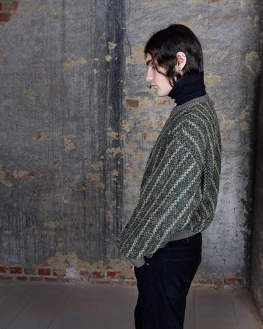 Get cozy in this playful Vintage 80s green sweater with colorful accents. Perfect for a casual day out, this striped sweater will keep you warm