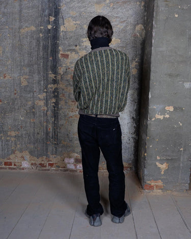 Get cozy in this playful Vintage 80s green sweater with colorful accents. Perfect for a casual day out, this striped sweater will keep you warm