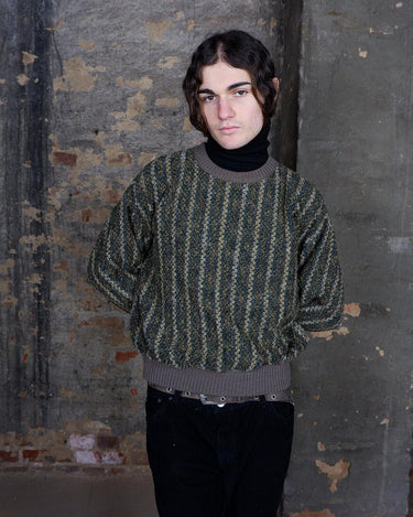 Get cozy in this playful Vintage 80s green sweater with colorful accents. Perfect for a casual day out, this striped sweater will keep you warm