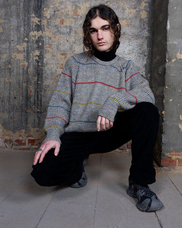 Embrace this colorful striped sweater. Perfect for a comfy, laid-back look!