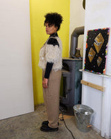 Cuddle up in this 90s vintage sweater, featuring a furry beige and dirty white design. The unique 1/2 sleeve style and attached shell add an extra touch of playful charm. We absolutely love this unique sweater! What about you? 