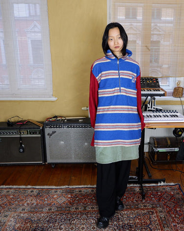 Get cozy in this vintage 90s red and blue striped half zip sweater. Perfect for those chilly days, this sweater is both stylish and comfortable. With its unique half zip design, you can easily adjust the neckline for the perfect fit.