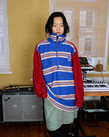 Get cozy in this vintage 90s red and blue striped half zip sweater. Perfect for those chilly days, this sweater is both stylish and comfortable. With its unique half zip design, you can easily adjust the neckline for the perfect fit.