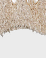 Cuddle up in this 90s vintage sweater, featuring a furry beige and dirty white design. The unique 1/2 sleeve style and attached shell add an extra touch of playful charm. We absolutely love this unique sweater! What about you? 