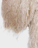 Cuddle up in this 90s vintage sweater, featuring a furry beige and dirty white design. The unique 1/2 sleeve style and attached shell add an extra touch of playful charm. We absolutely love this unique sweater! What about you? 