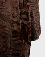Add a touch of eccentricity to your wardrobe with this vintage 80s long brown leather fur coat. Featuring unique patchwork leather and a cozy fur lining, this XL-XXL coat is perfect for making a bold statement
