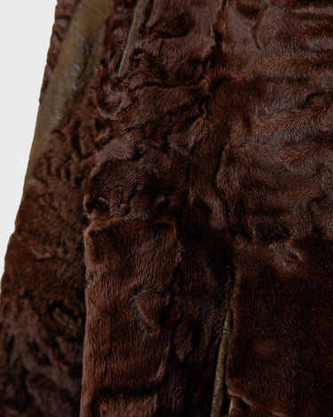 Add a touch of eccentricity to your wardrobe with this vintage 80s long brown leather fur coat. Featuring unique patchwork leather and a cozy fur lining, this XL-XXL coat is perfect for making a bold statement