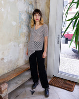 Preloved and handmade, this silver crochet top catches the light with its soft shimmer. The open-knit design and asymmetrical cut give it that effortless, worn-in feel. A rare find that’s easy to style and full of character.