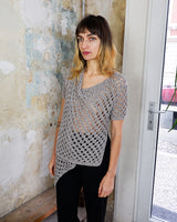 Preloved and handmade, this silver crochet top catches the light with its soft shimmer. The open-knit design and asymmetrical cut give it that effortless, worn-in feel. A rare find that’s easy to style and full of character.