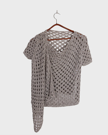 Preloved and handmade, this silver crochet top catches the light with its soft shimmer. The open-knit design and asymmetrical cut give it that effortless, worn-in feel. A rare find that’s easy to style and full of character.