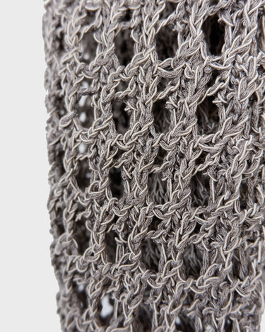Preloved and handmade, this silver crochet top catches the light with its soft shimmer. The open-knit design and asymmetrical cut give it that effortless, worn-in feel. A rare find that’s easy to style and full of character.