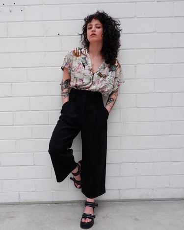 Look your wildest in our Crazy pattern short sleeve light shimmering blouse! This tailored fit gives you a sleek silhouette that shimmers in the light! Featuring a unique pattern, you'll be making an elegant statement everywhere you go! Shimmy on!