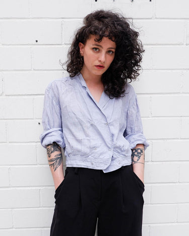   A sprinkle of '80s! This vintage crop blouse in light blue & lavender undertone will add some elegant vibes to your wardrobe. Get groovy with its 100% linen fabric!