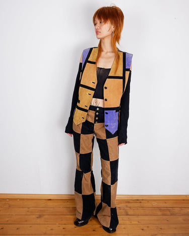 Calling all patchwork enthusiasts! This 80s vest features a vibrant combination of purple, camel brown, and black leather, adding some edginess to any outfit! Ready?Calling all patchwork enthusiasts! This 80s vest features a vibrant combination of purple, camel brown, and black leather, adding some edginess to any outfit! Ready?