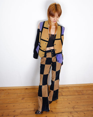 Calling all patchwork enthusiasts! This 80s vest features a vibrant combination of purple, camel brown, and black leather, adding some edginess to any outfit! Ready?Calling all patchwork enthusiasts! This 80s vest features a vibrant combination of purple, camel brown, and black leather, adding some edginess to any outfit! Ready?