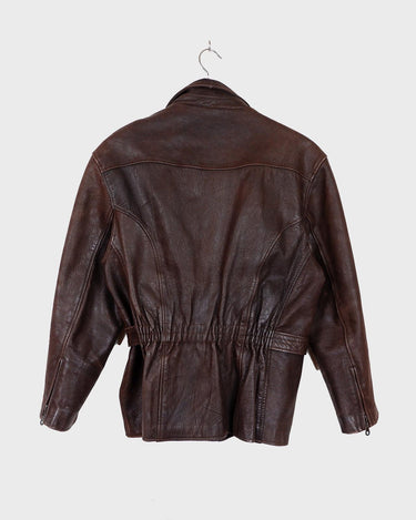 Look sharp in this vintage 80s chocolate brown belted biker leather jacket! Be the baddest biker on the block with this classic piece. Perfect for adding some edge to your look with a bit of attitude. Get ready to hit the highway!