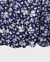 Dress to impress in this vintage 90s blue midi dress with a floral pattern! Tie it tighter for an S-M fit or let it go for a L-XL! Get yours now and get dressed to express!