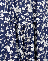 Dress to impress in this vintage 90s blue midi dress with a floral pattern! Tie it tighter for an S-M fit or let it go for a L-XL! Get yours now and get dressed to express!