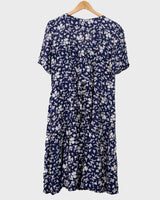 Dress to impress in this vintage 90s blue midi dress with a floral pattern! Tie it tighter for an S-M fit or let it go for a L-XL! Get yours now and get dressed to express!