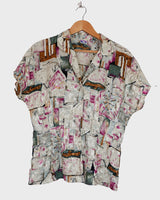 Look your wildest in our Crazy pattern short sleeve light shimmering blouse! This tailored fit gives you a sleek silhouette that shimmers in the light! Featuring a unique pattern, you'll be making an elegant statement everywhere you go! Shimmy on!