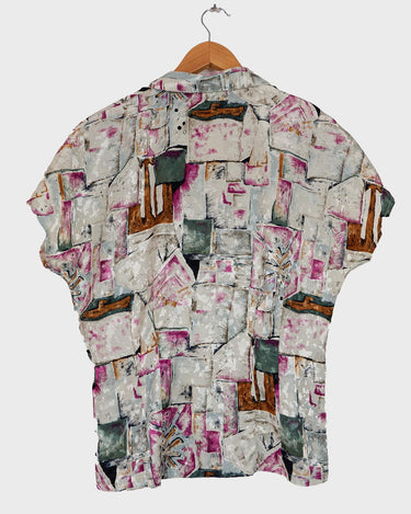 Look your wildest in our Crazy pattern short sleeve light shimmering blouse! This tailored fit gives you a sleek silhouette that shimmers in the light! Featuring a unique pattern, you'll be making an elegant statement everywhere you go! Shimmy on!