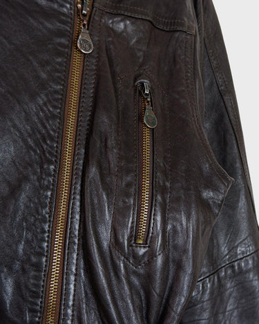 Experience the rustic charm of this vintage 80s chocolate brown leather biker jacket! The buttery-soft leather is sure to make you feel like you’re in the driver’s seat of life. Complete with a belt closure, this jacket is an ideal choice for a stylish and timeless look. Rev up your wardrobe today!