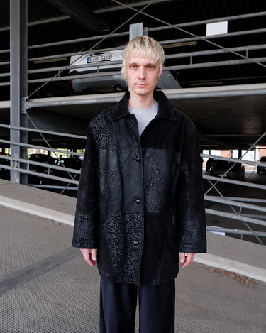 Vintage 80s black leather coat with patchwork design, textured dot panels and shoulder pads | L-XL