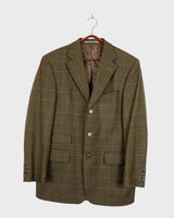 Get ready to make a statement with this Vintage 80s green checkered pattern blazer! Featuring shoulder pads for a bold silhouette, this blazer exudes casual vibes with a playful twist.