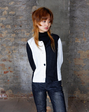 Rockin' 80s vibes with this black and white color blocking linen blouse! Perfect for any vintage lover, this blouse offers a playful twist on a classic look. Add it to your collection for a unique look.