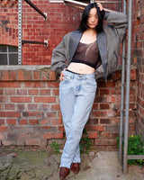 Own a piece of classic 80s style with this eye-catching vintage grey striped jacket! Crafted from a vegan leather and wool mix, it's got a deep cut and a belt to give it that extra special something. (Note: Definitely one of my favourite jackets so far)