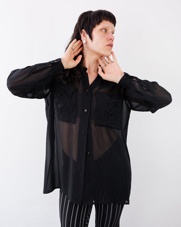 Vintage 80s 90s black mesh long sleeve blouse with embroidered front pockets and shoulder pads | S-XL
