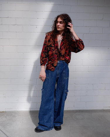 This Vintage 80s blouse is eccentric and elegant in all the right places! With its eye-catching crazy pattern and elastic hem, you'll be ready to go! So, if you're looking for something a little wild, this is the one for you! Please keep in mind, that the sleeves are shorter than usual.
