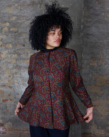 Unleash your inner vintage goddess with this playful 80s burgundy paisley blouse. Featuring a flattering a-form cut and long sleeves, it's the perfect addition to your wardrobe.
