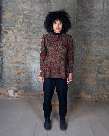 Unleash your inner vintage goddess with this playful 80s burgundy paisley blouse. Featuring a flattering a-form cut and long sleeves, it's the perfect addition to your wardrobe.