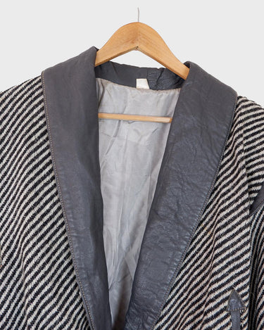 Own a piece of classic 80s style with this eye-catching vintage grey striped jacket! Crafted from a vegan leather and wool mix, it's got a deep cut and a belt to give it that extra special something. (Note: Definitely one of my favourite jackets so far)