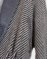 Own a piece of classic 80s style with this eye-catching vintage grey striped jacket! Crafted from a vegan leather and wool mix, it's got a deep cut and a belt to give it that extra special something. (Note: Definitely one of my favourite jackets so far)