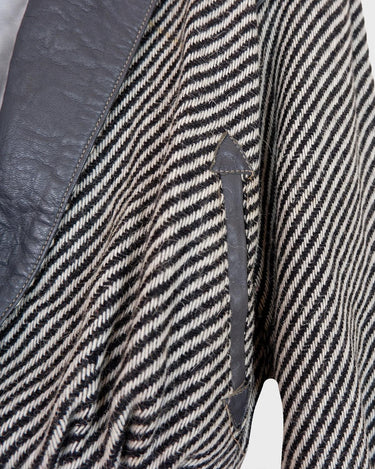 Own a piece of classic 80s style with this eye-catching vintage grey striped jacket! Crafted from a vegan leather and wool mix, it's got a deep cut and a belt to give it that extra special something. (Note: Definitely one of my favourite jackets so far)