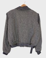 Own a piece of classic 80s style with this eye-catching vintage grey striped jacket! Crafted from a vegan leather and wool mix, it's got a deep cut and a belt to give it that extra special something. (Note: Definitely one of my favourite jackets so far)