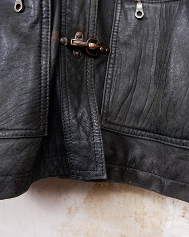 Introducing this Vintage 80s black fireman clasp leather coat, a must-have piece for your collection. Made of buttery soft leather, this coat exudes a cool and edgy vibe.