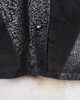 This vintage black leather coat blends matte suede leather with subtly glossy smooth leather panels in rich black tones. The unique patchwork design, featuring delicate dot-textured sections, adds depth, texture, and quiet individuality. With its sleek cut, button front, and spacious pockets, this timeless piece is full of character – perfect for those who appreciate quality and one-of-a-kind style.
