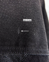 This vintage black leather coat blends matte suede leather with subtly glossy smooth leather panels in rich black tones. The unique patchwork design, featuring delicate dot-textured sections, adds depth, texture, and quiet individuality. With its sleek cut, button front, and spacious pockets, this timeless piece is full of character – perfect for those who appreciate quality and one-of-a-kind style.