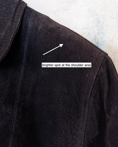 This vintage black leather coat blends matte suede leather with subtly glossy smooth leather panels in rich black tones. The unique patchwork design, featuring delicate dot-textured sections, adds depth, texture, and quiet individuality. With its sleek cut, button front, and spacious pockets, this timeless piece is full of character – perfect for those who appreciate quality and one-of-a-kind style.