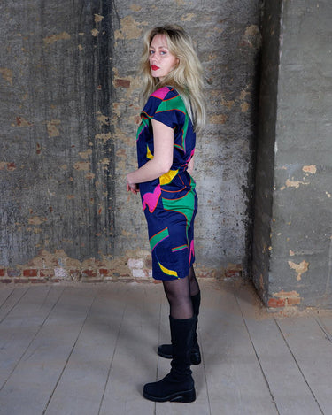 Add a splash of fun to your wardrobe with this colorful, vintage 80s short sleeve dress. The light, transparent fabric adds an eclectic touch, perfect for making a statement and adding a pop of color.