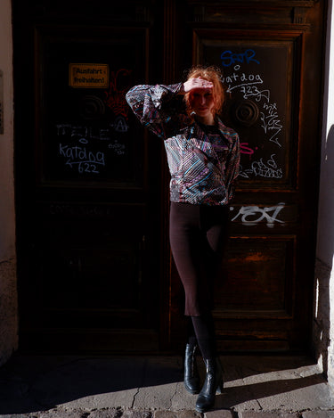 Get ready to make a statement with this vintage 80s transparent wrap blouse! The unique volant sleeves add a touch of playfulness to this colorful piece.