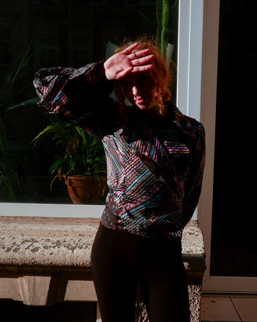 Get ready to make a statement with this vintage 80s transparent wrap blouse! The unique volant sleeves add a touch of playfulness to this colorful piece.