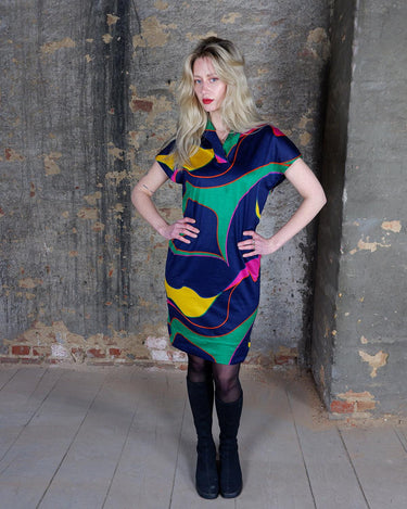 Add a splash of fun to your wardrobe with this colorful, vintage 80s short sleeve dress. The light, transparent fabric adds an eclectic touch, perfect for making a statement and adding a pop of color.