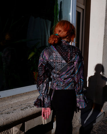 Get ready to make a statement with this vintage 80s transparent wrap blouse! The unique volant sleeves add a touch of playfulness to this colorful piece.